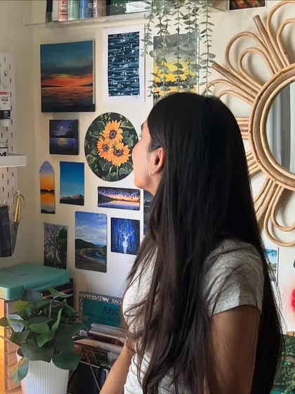 Another photo of me admiring my wall of art. It’s a constant source of inspiration and a reminder of how far I’ve come.