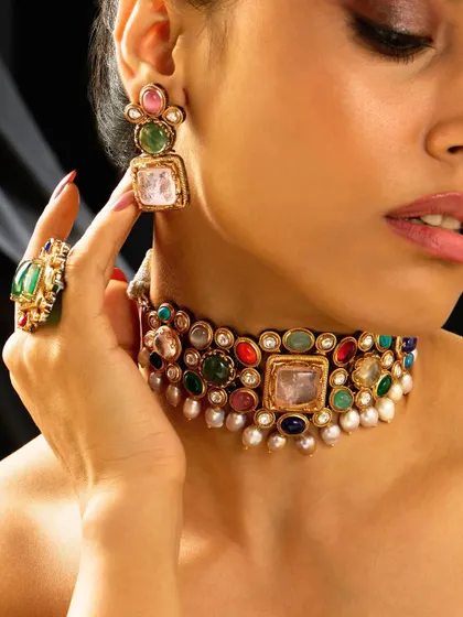 A bold Navratna-style choker with a variety of colorful gemstones and pearls, perfect for adding a vibrant touch to any outfit.