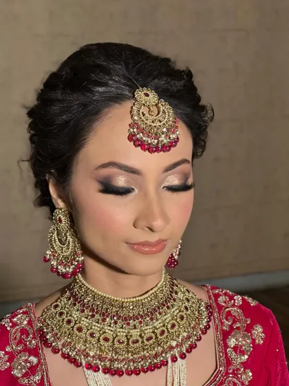 The full effect of the glittery eye makeup. This look is perfect for brides who want a touch of sparkle and drama for their main event.