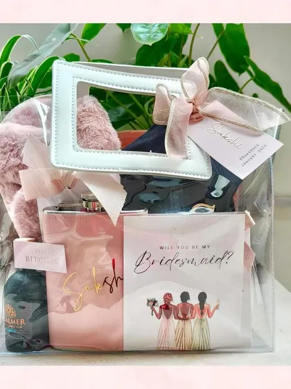A single bridesmaid proposal bag, showing all the curated items inside. The pink and white theme creates a chic and feminine look.