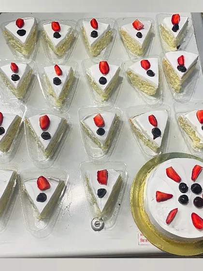 An overhead view of our Milk Pastry slices being prepared for a bulk order, ensuring each piece is perfect.