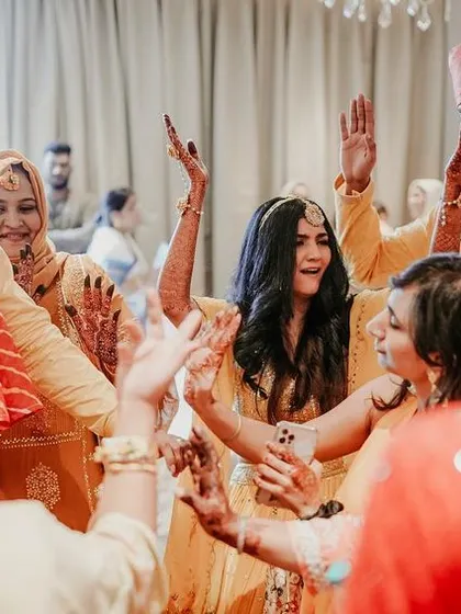 The bride and her friends and family dancing together, a shot full of energy and happiness.