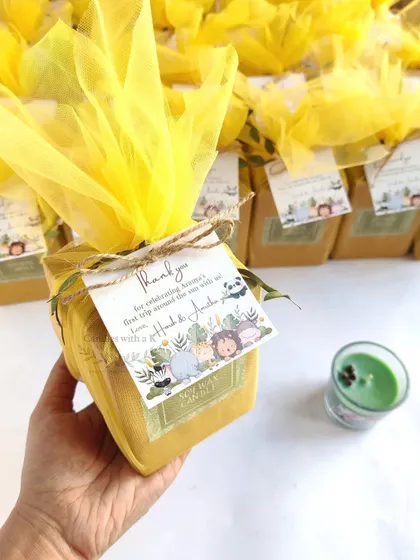 The jungle-themed birthday favors, all wrapped in bright yellow net with personalized thank you cards.