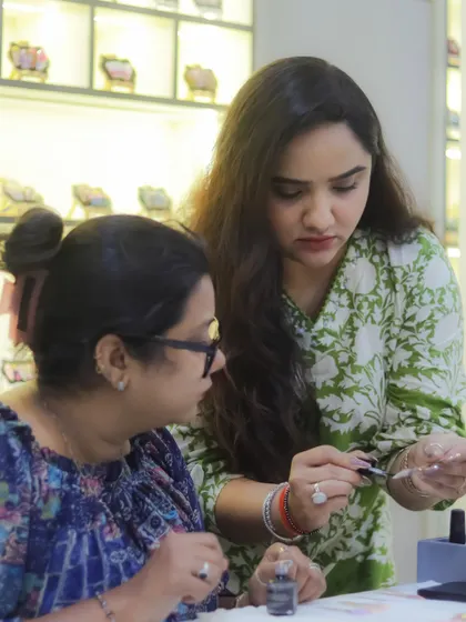 Another shot of our founder mentoring a student. We are committed to nurturing the next generation of nail artists with expert guidance.