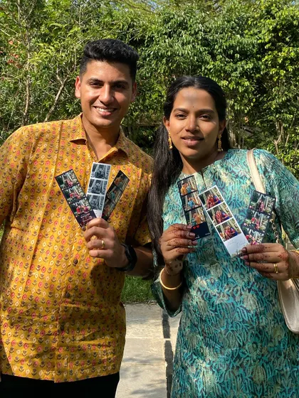 Happy guests proudly showing off their photo strips. It's a perfect wedding favor that everyone loves, giving them a personal memento to take home from your special day.