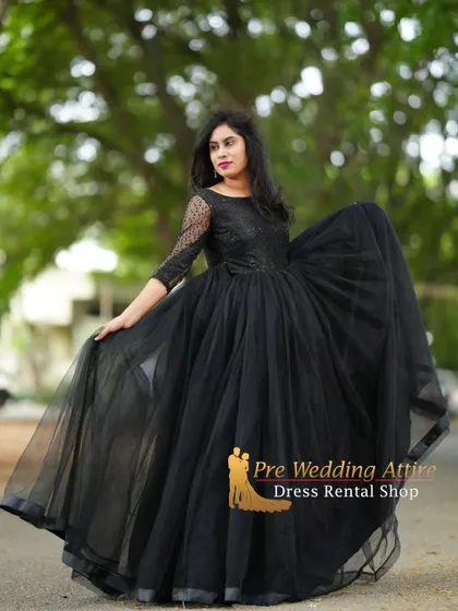The black ball gown in a slight side profile, showing the flattering shape of the bodice and skirt.
