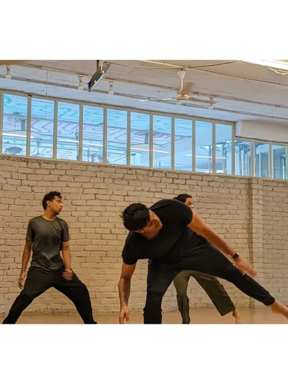 A dynamic shot of students practicing a traveling sequence across the floor, showcasing energy and coordination.