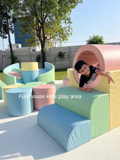 A happy child peeking through the pastel tunnel. Our designs encourage exploration and imaginative play.