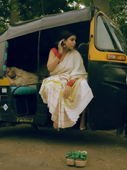 Capturing candid moments in unexpected places. This shot uses a Mumbai auto-rickshaw as a prop, adding a layer of authentic city life to this traditional saree portrait.