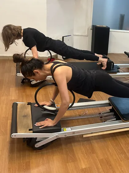 Various shots of members and instructors in action during our dynamic Reformer Pilates classes.