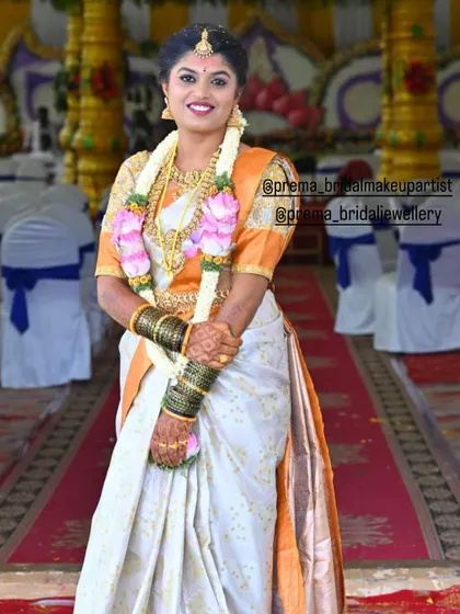 The bride looks radiant and happy in her full bridal attire.