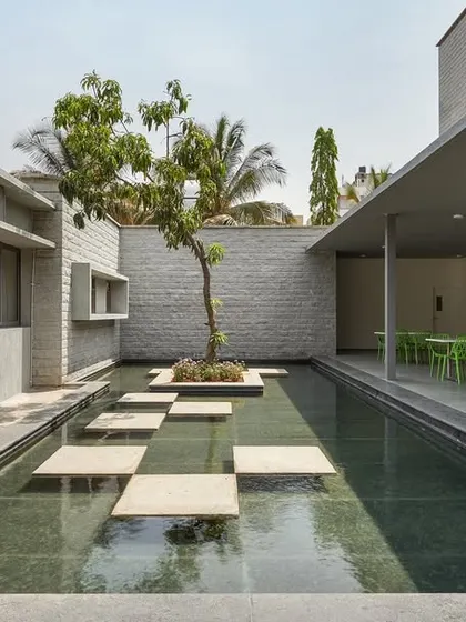A water court with stepping stones next to the canteen at KIPCER. Water is used as a key element to create a soothing and reflective atmosphere.