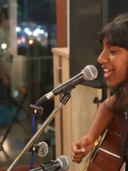 A vocalist and guitarist sharing a smile during their performance. We love seeing artists enjoy themselves on our stage.
