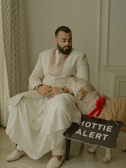 Even the furry family members get in on the action. This adorable shot of the groom, Vikash, with his dog (the "hottie alert") is a heartwarming and personal moment that shows a different side of the wedding day.