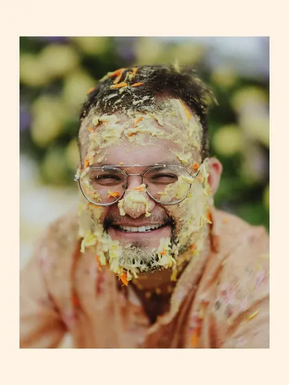 A duplicate of the groom's happy, haldi-covered face, a classic shot of the ceremony.