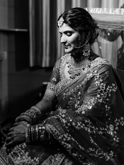I love using black and white to create dramatic and timeless portraits. This image of a North Indian bride captures a moment of quiet reflection, with the monochrome tones emphasizing the rich embroidery of her lehenga.