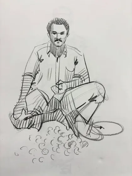 A sketch of a man preparing food on the ground, capturing a moment of daily work.