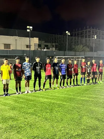 Discipline comes first. A coach addresses the team, reinforcing the values of hard work, dedication, and respect that are the foundation of our academy.