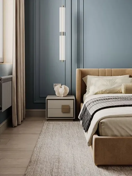 A close-up shot of the bedside area in the blue bedroom, showing the nightstand and pendant light.