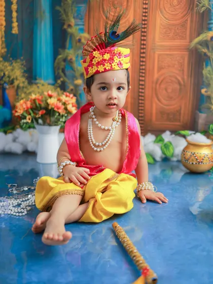 A direct and engaging look from this baby Krishna. I always try to capture these moments of connection, where their personality truly shines through.