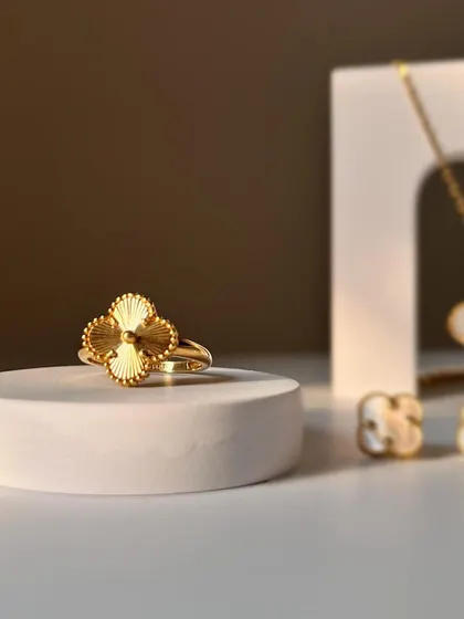 A close up of the four leaf clover ring in textured gold, a beautiful piece that can be worn as a daily reminder of hope or a statement for a special occasion.