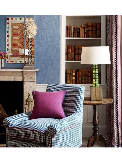 This cozy nook is a perfect example of how wallpaper and upholstery can work together to create a charming vibe. The mix of the houndstooth chair, textured wall, and patterned curtains is a beautiful exercise in layering.