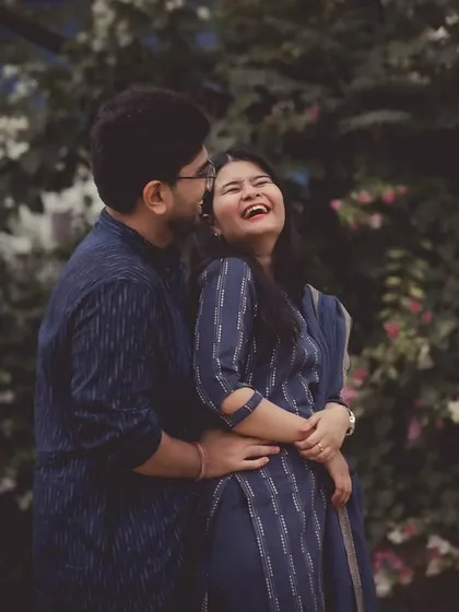 A beautiful, candid moment of laughter between a couple, captured with a classic, slightly faded color treatment for a timeless feel.