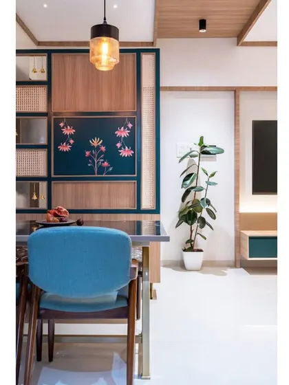A view from the dining chair, looking towards the living room. The use of color and custom art creates a vibrant and cohesive home environment.