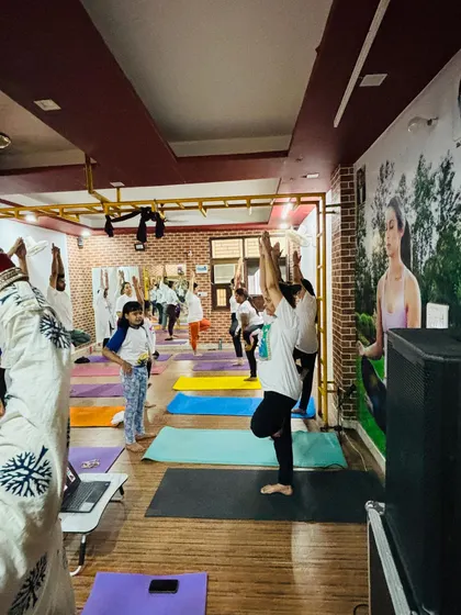 Students practicing Vrikshasana (Tree Pose) during our International Yoga Day event. The focus and balance of the group is wonderful to see.