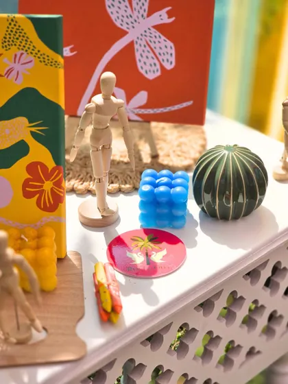 A collection of the unique, art-inspired decor items used for the Haldi, including custom-painted canvases and colorful bubble candles.