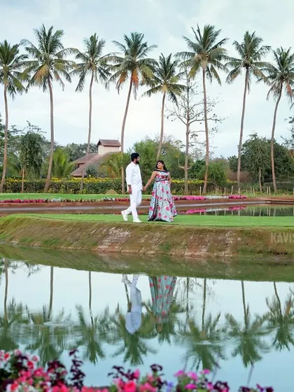 A stunning reflection shot of the couple and palm trees in the water, adding an artistic touch to their pre-wedding gallery.