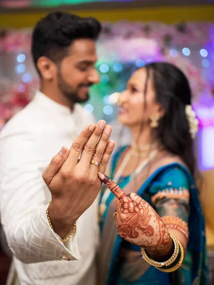 A playful photo showing off the engagement rings, a creative way to announce their commitment.
