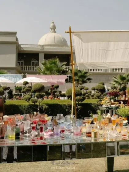 The main bar at the personalized Mehendi, featuring a mirrored table reflecting the colorful cocktails and a large sculpture of a bunny on a coffee cup, a key element of the couple's story.