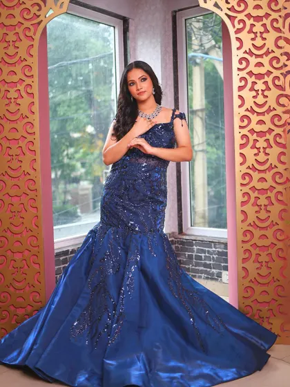 A full-length view of the royal blue fish-cut gown with its dramatic train.
