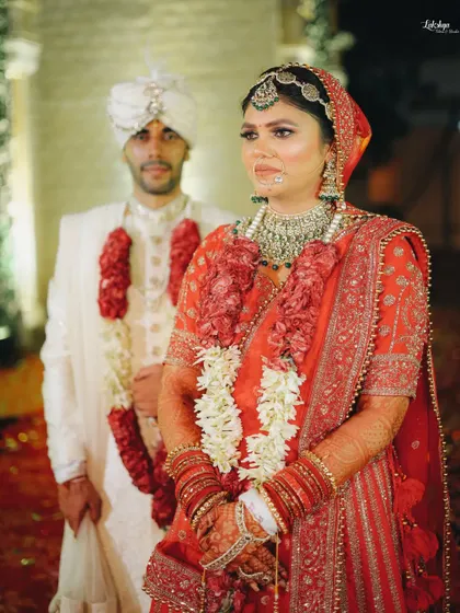 A candid moment during the wedding ceremony. This photo captures the bride's expression during a solemn ritual, with her groom standing by her side.