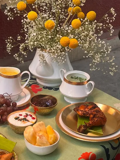 A detail shot from our Eid spread, showing the variety of dishes. You can see the roasted chicken leg, fresh jackfruit, creamy raita, and sweet dates that accompany the main meal.