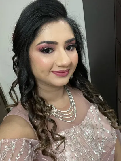 She looks absolutely radiant with this HD party makeup. The pink tones complement her outfit and skin tone perfectly.