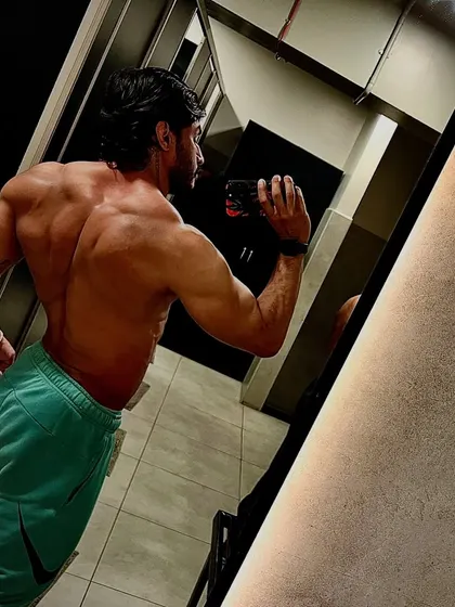 A mirror selfie from the side, showing the complete package. This physique was not built for anyone's approval but my own.