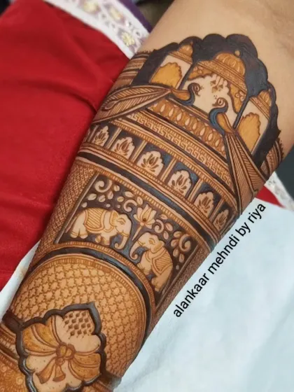 A close-up of the completed design, showcasing the rich texture and detail of the peacocks, elephants, and lotus flowers.