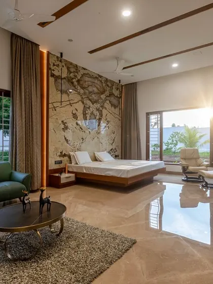 This expansive primary suite combines a bedroom and living area in one open space. It features a floating bed, a large seating area, and floor-to-ceiling windows with views of the garden.