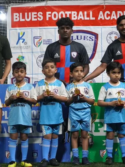 Our youngest champions, the toddler batch, proudly display their first trophies alongside their coaches.