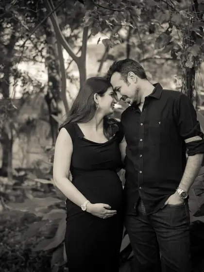 A black and white portrait that feels both classic and intimate. The soft focus on the background makes the couple and their connection the absolute center of the image.