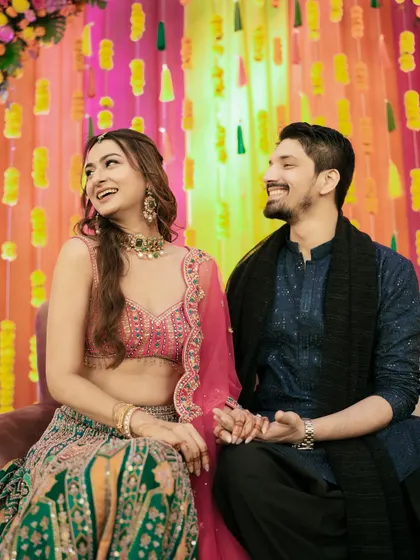 A shared laugh during the Mehndi ceremony. These are the candid, in-between moments that truly define your story.