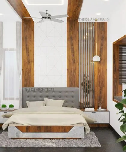 A 3D render of a master bedroom design, showcasing a tufted grey headboard against a backdrop of wood paneling and geometric wallpaper. The design includes elegant ceiling beams and a bay window seating area for a touch of luxury.