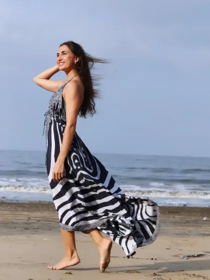 A walking shot on the sand, creating a sense of movement and narrative. This type of image is great for lifestyle or fashion stories set in a natural environment.