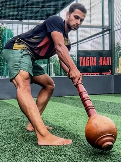 A powerful stance with the Gada, ready for movement. This image captures the essence of our PRAHAAR program, which uses ancient tools to build modern functional strength, focusing on posture, mobility, and power.