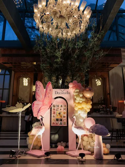 A wider view of the memory lane photo display, showing how it fits into the grand, high-ceilinged venue with an ornate chandelier above.