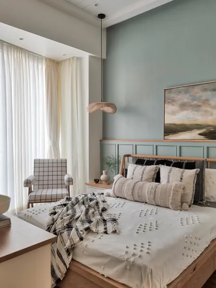 This is the overall look of a daughter's room where we incorporated the balcony to make the room feel bigger. The sage green wall, combined with wooden textures and white tones, makes the space feel both spacious and homely.