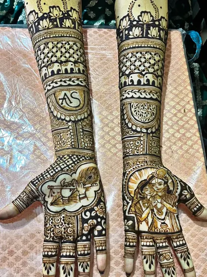 A divine love story featuring portraits of Radha and Krishna. This spiritual and artistic design is perfect for a bride who wants to incorporate her faith into her bridal mehndi.