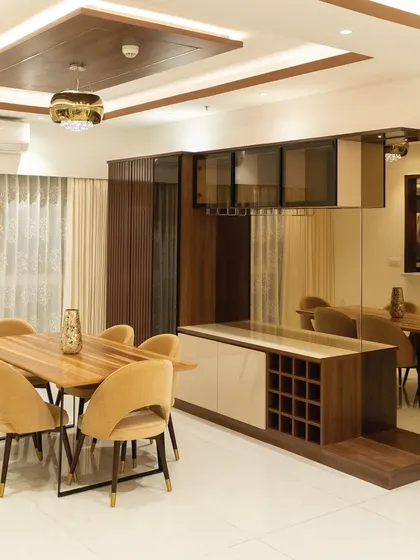 For this 3BHK apartment at SNN Claremont, the goal was an open and inviting dining area. I used a mirrored wall and a custom crockery unit with a wine rack to make the space feel larger and more functional, perfect for entertaining.